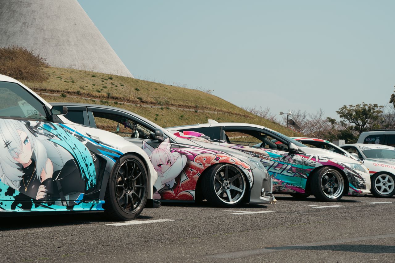 unique street cars with anime vinyl art parked outdoors in tokyo ideal