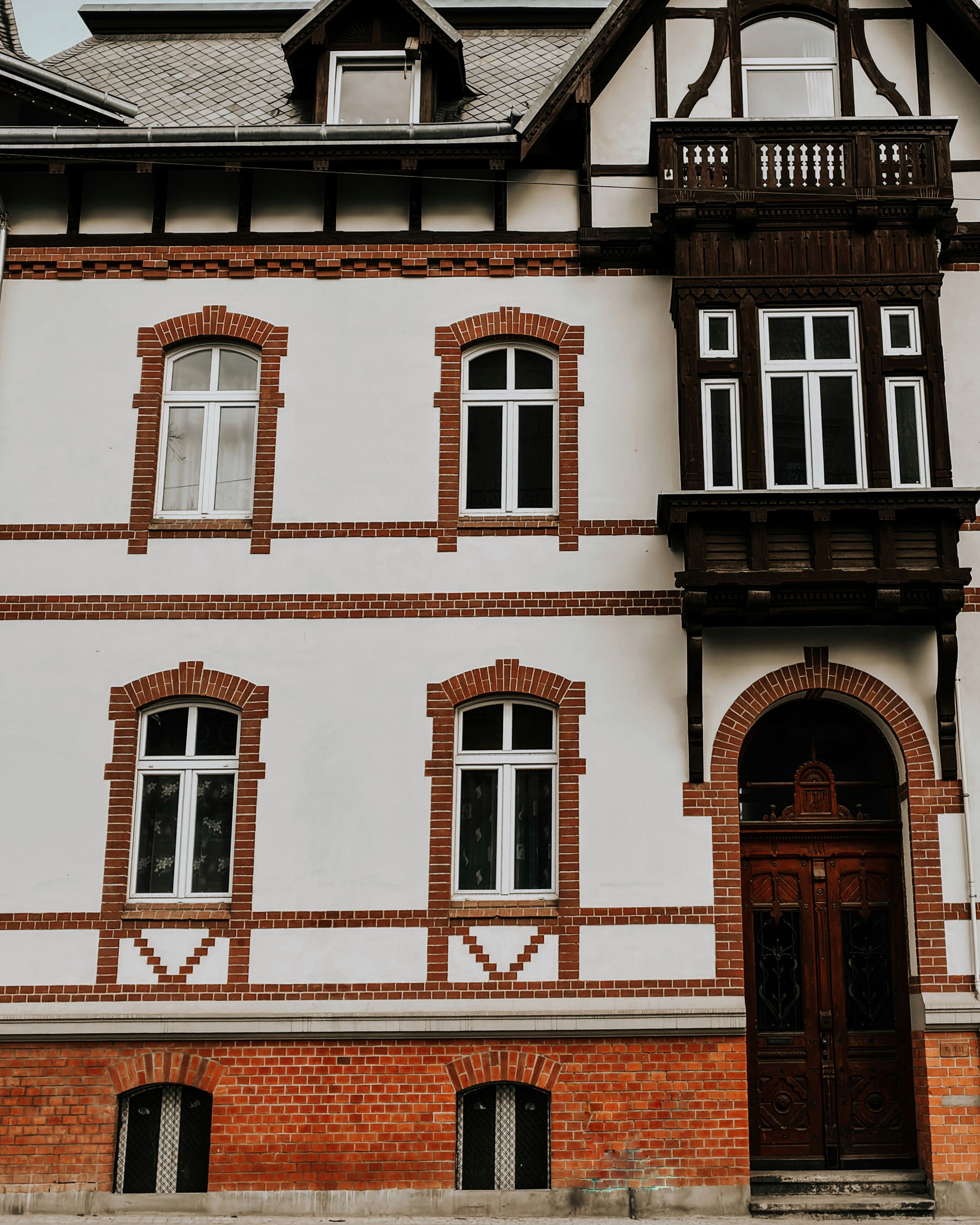 Classic European building facade with brick and timber details, showcasing historic architectural design.