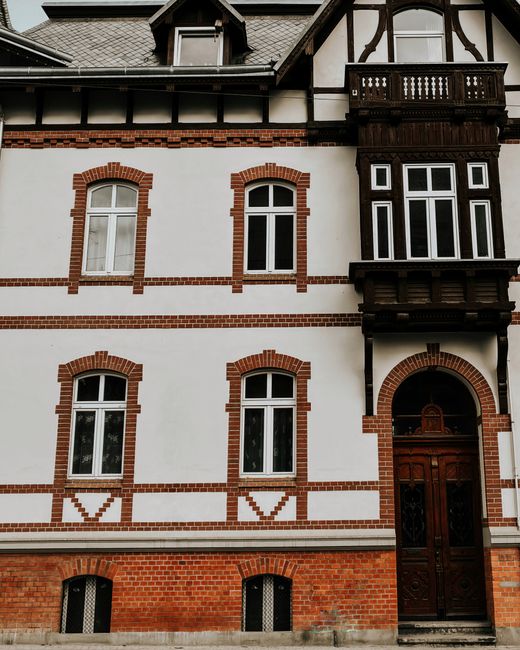 Classic European building facade with brick and timber details, showcasing historic architectural design.