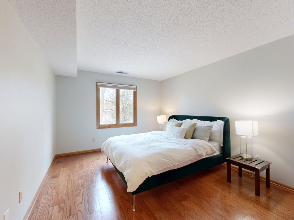 Minimalist bedroom inspo ideas with white bedding and wooden flooring