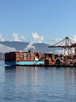 A cargo ship docked at a shipping container terminal in Vancouver, Canada.