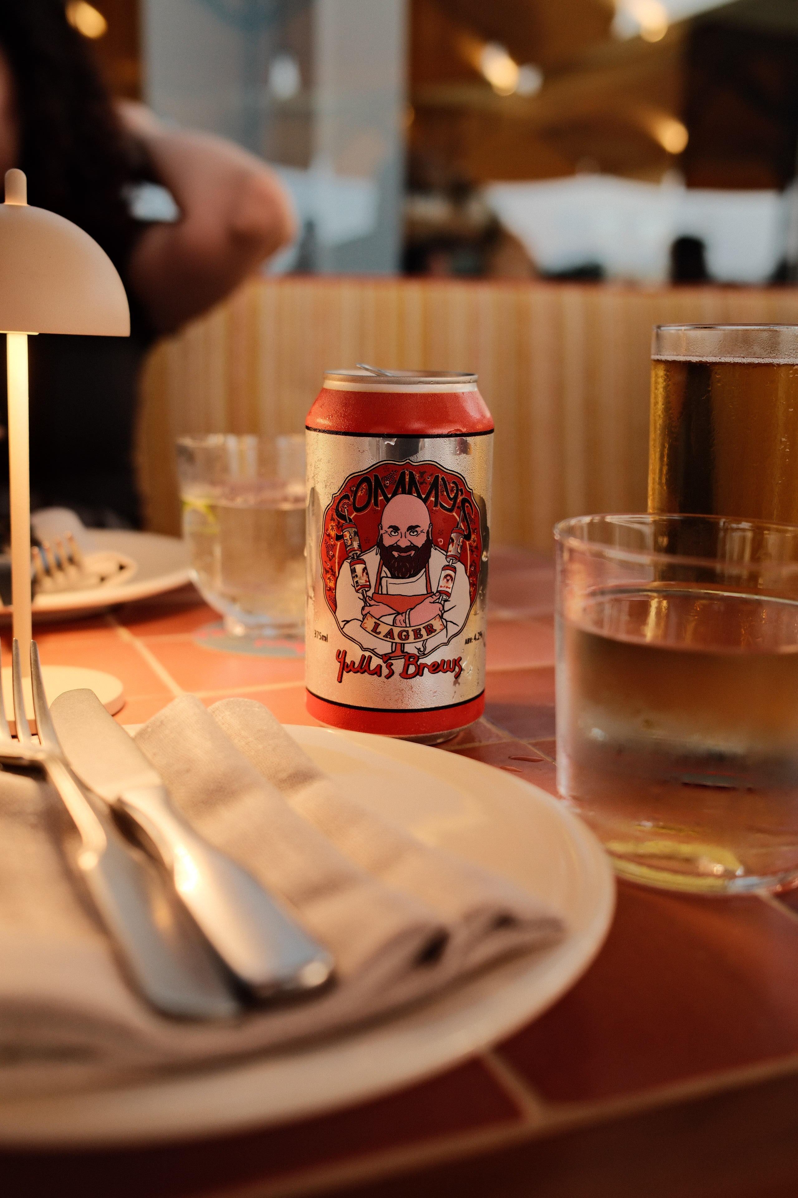 A warm dining setting with drinks and beer can at a Sydney restaurant.