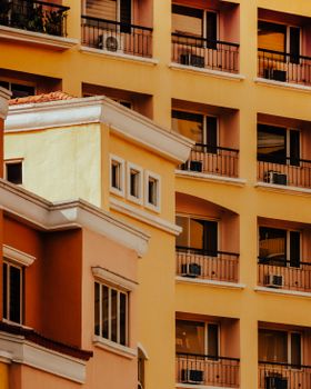Close-up of vibrant yellow and orange condominium buildings in Taguig, Philippines.