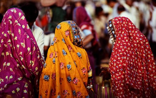 Free Colorful Indian women in traditional sarees at a bustling outdoor market Stock Photo