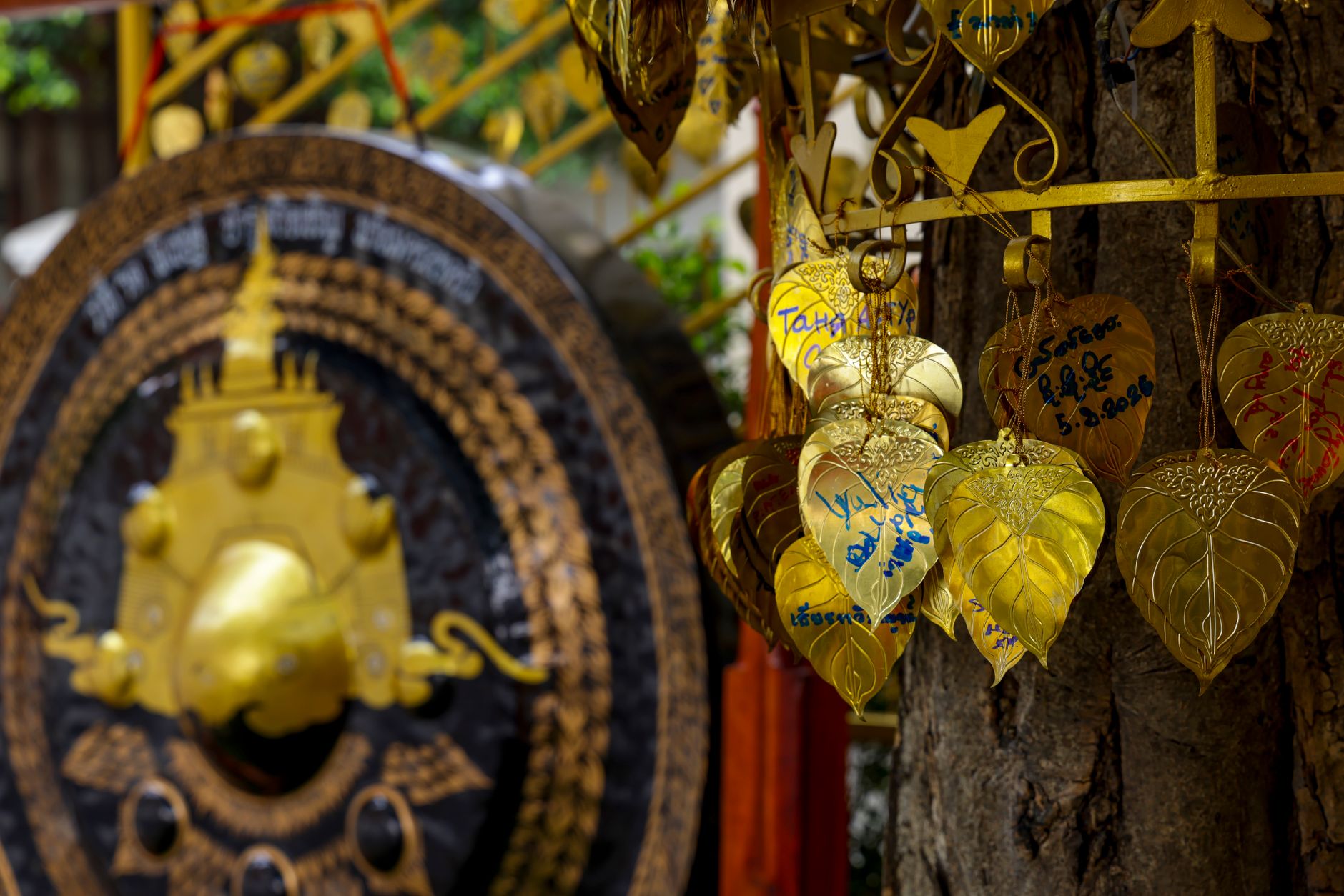 Close-up of golden leaves and gong at a Thai temple in Bangkok, Thailand.