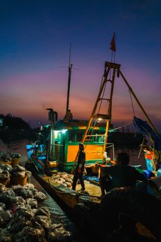 A colorful fishing boat docked at Vũng Tàu harbor during twilight, exemplifying coastal life.