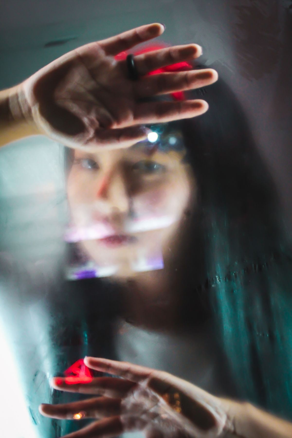 Woman looking through a foggy window, reflecting on betrayal blindness and missed signs