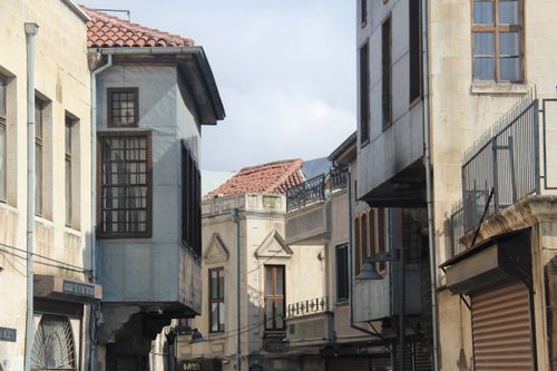 Free Street view of historic Mediterranean buildings with classic facades and red tile roofs. Stock Photo