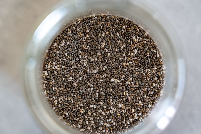 chia pudding layered with berries in a small jar