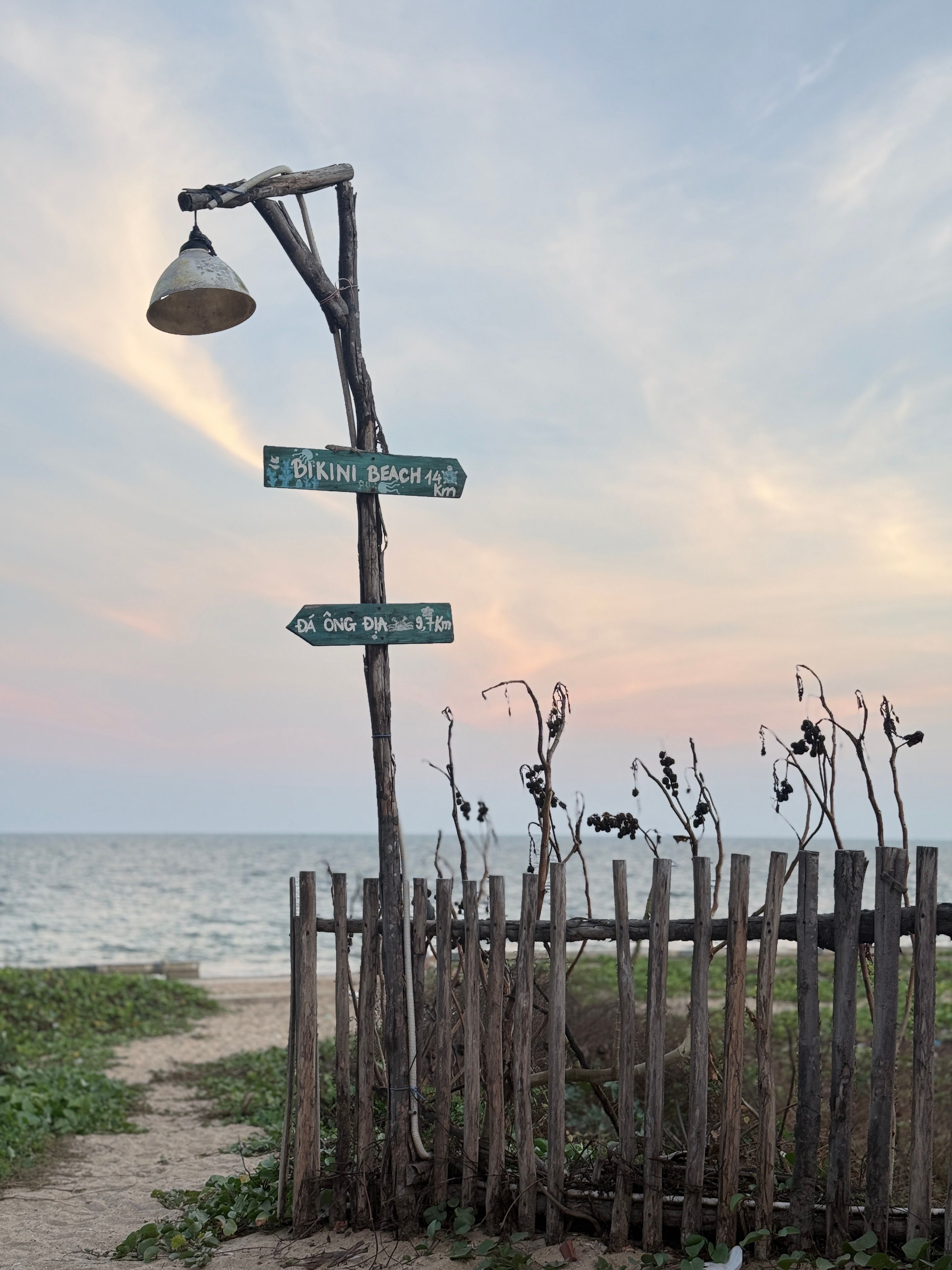 Rustic Signpost at Sunrise on Phan Thiet Beach · Free Stock Photo