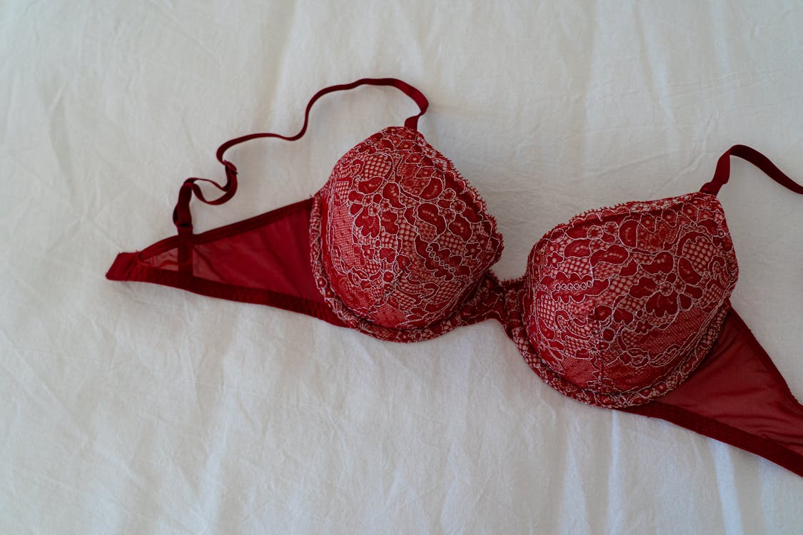 Red Brassiere on White Textile · Free Stock Photo