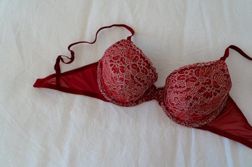 Free Red Brassiere on White Textile Stock Photo