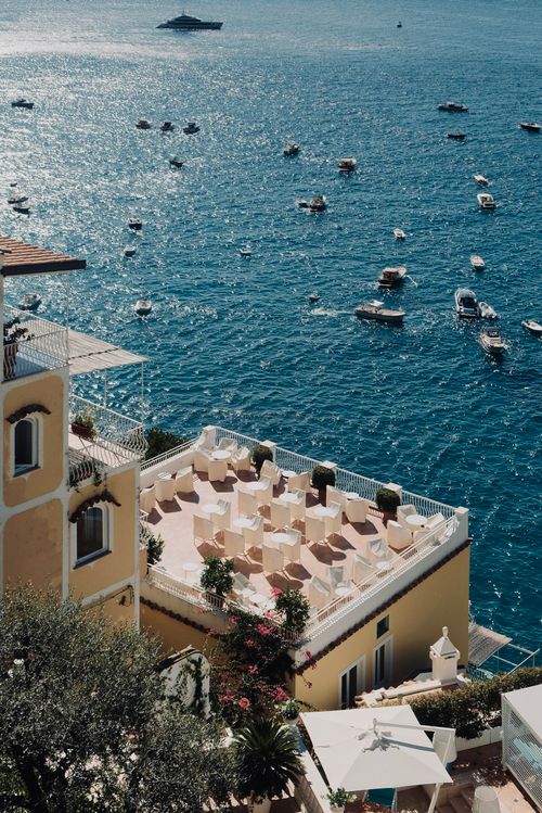 Free Aerial view of the Mediterranean coast in Campania, Italy with luxury yachts and azure waters. Stock Photo