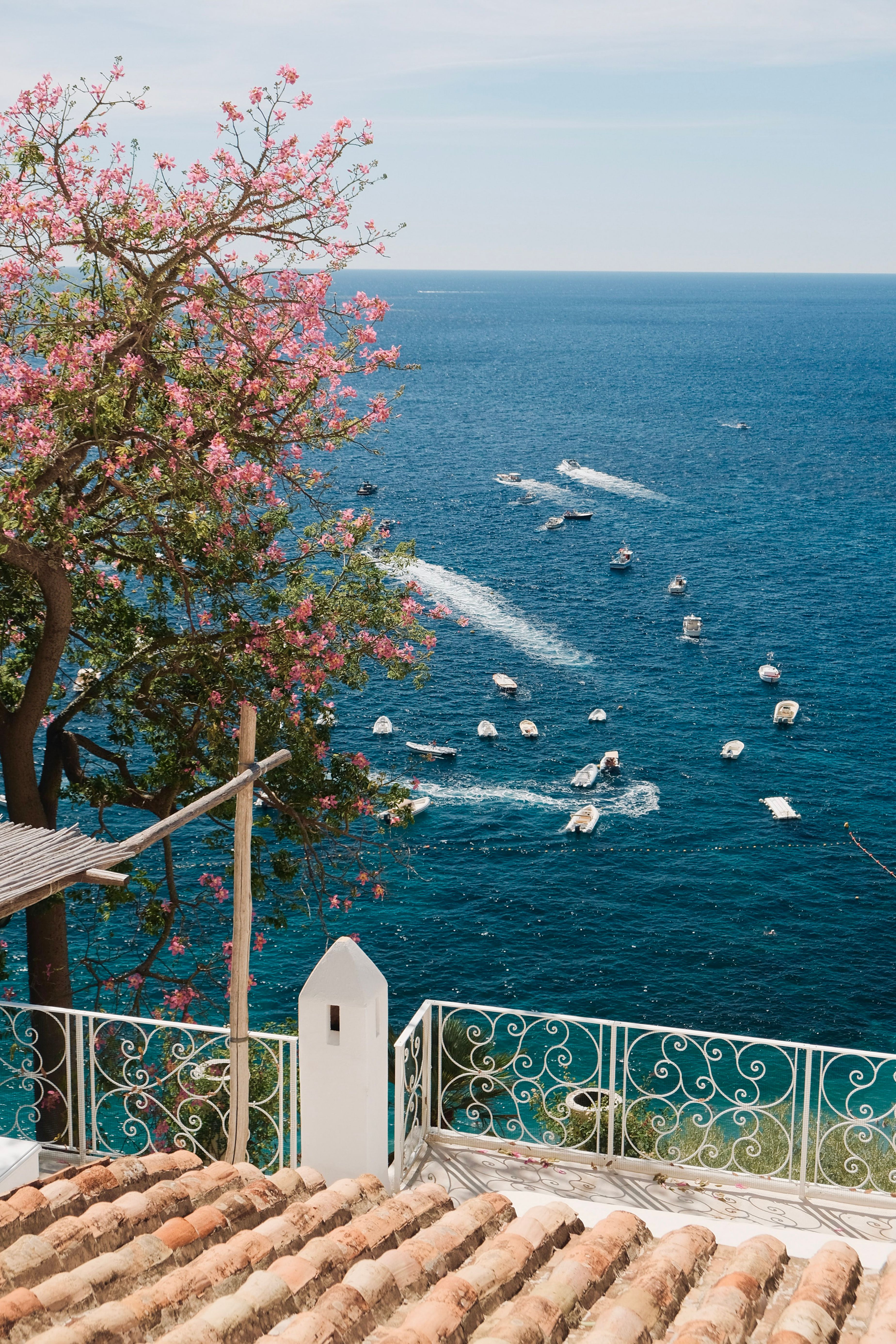 Stunning view of boats on the Mediterranean Sea from a terrace in Campania, Italy.