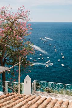 Stunning view of boats on the Mediterranean Sea from a terrace in Campania, Italy.
