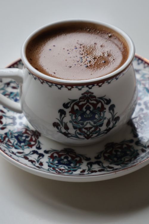 Free A steaming cup of Turkish coffee served in a beautifully decorated cup and saucer. Stock Photo