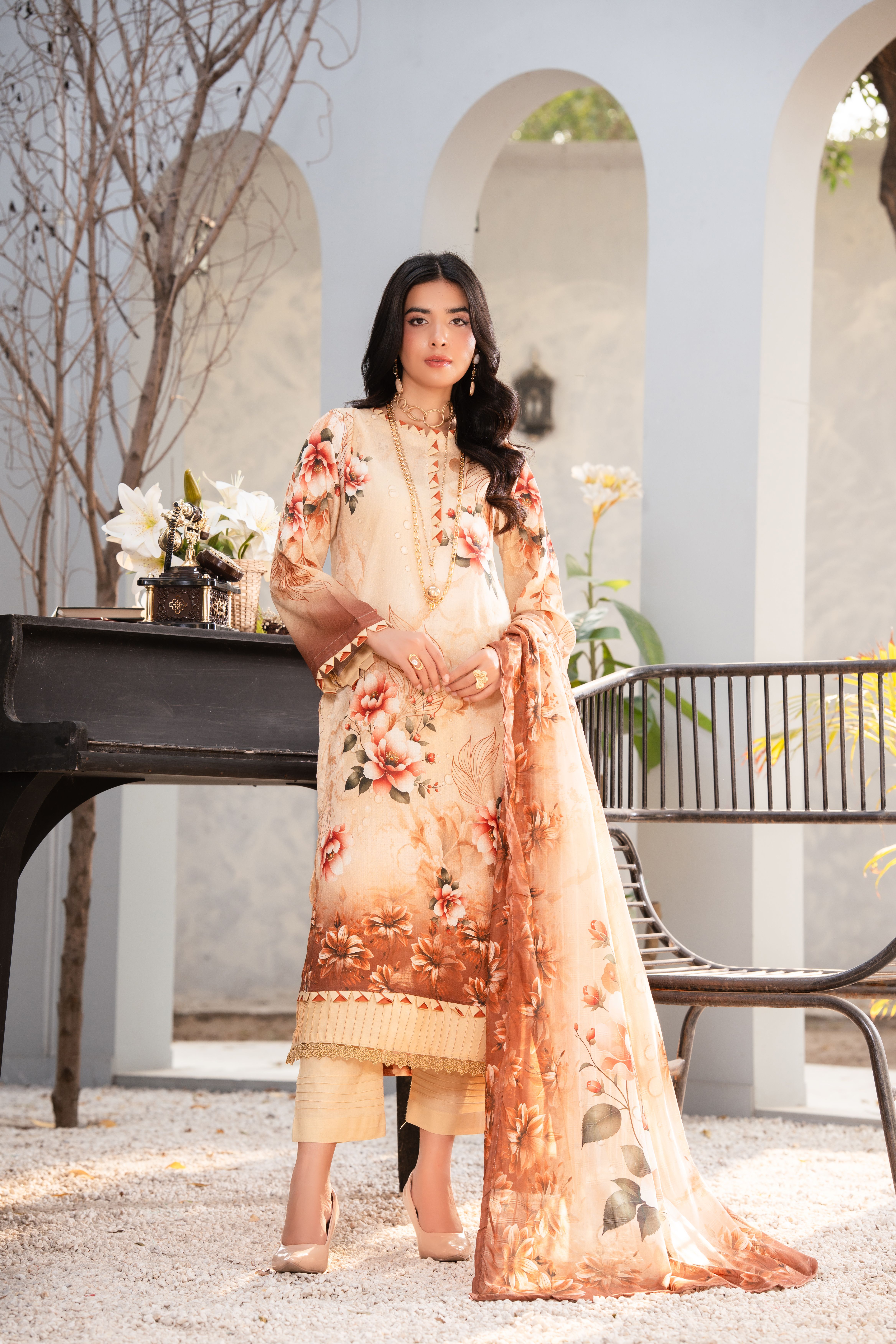 Portrait of a woman in a floral dress indoors, blending elegance and modernity.