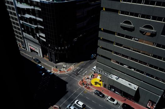 High-angle urban street view with modern buildings and city traffic.