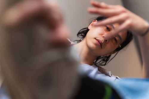 Free Close-up portrait of a person in thoughtful expression and blurred hand movement. Stock Photo
