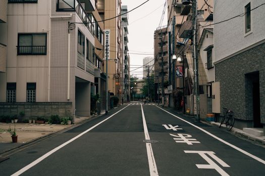 Urban street scene showcases a serene Japanese neighborhood with traditional architecture.