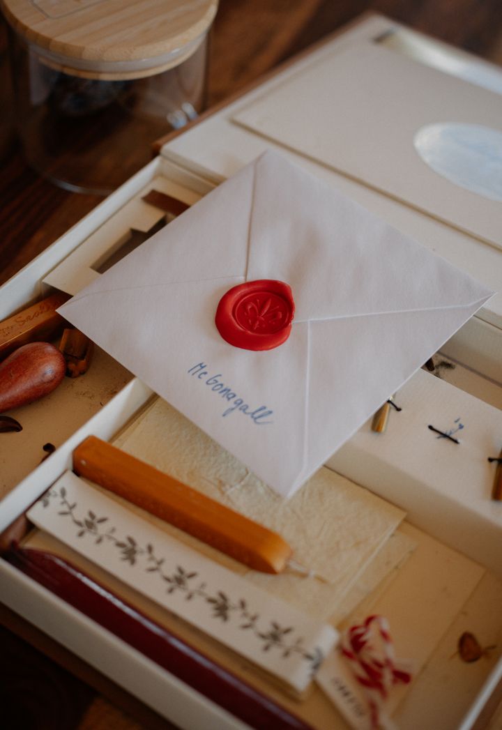 Envelope sealed with red wax on a writing desk