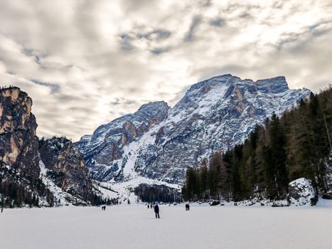 Stunning snowy mountain range with frozen lake, perfect for winter sports and scenic photography.