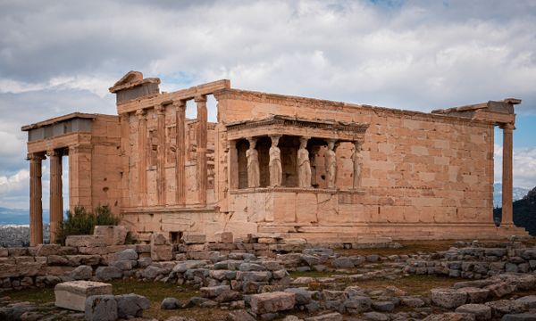 View of the ancient Erechtheion Temple with its iconic Caryatids, located at the Acropolis in Athens, Greece.