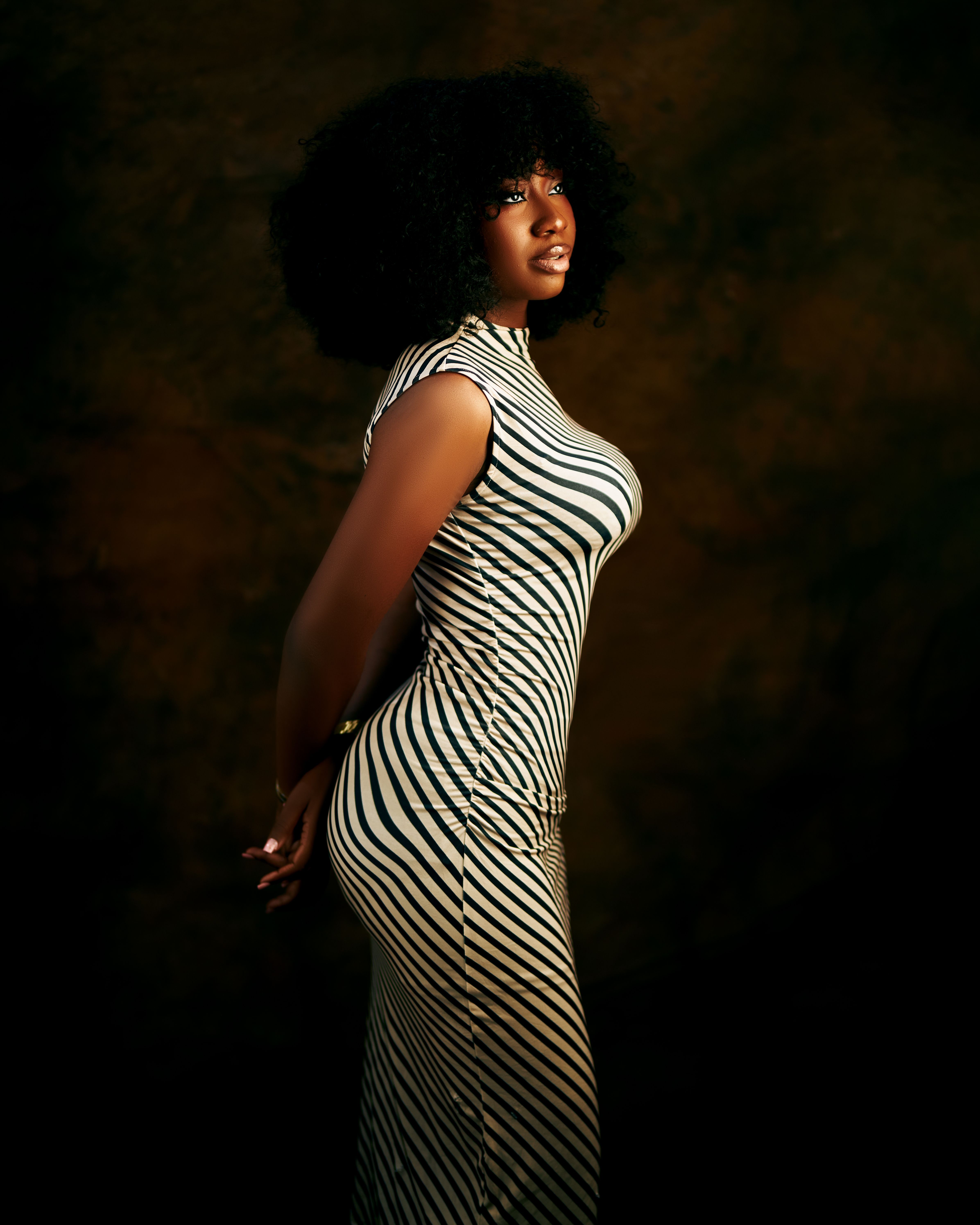 Elegant Portrait of Woman in Striped Dress · Free Stock Photo