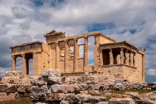 Free Erechtheion Temple with iconic Caryatids in Athens under a dramatic sky. Stock Photo