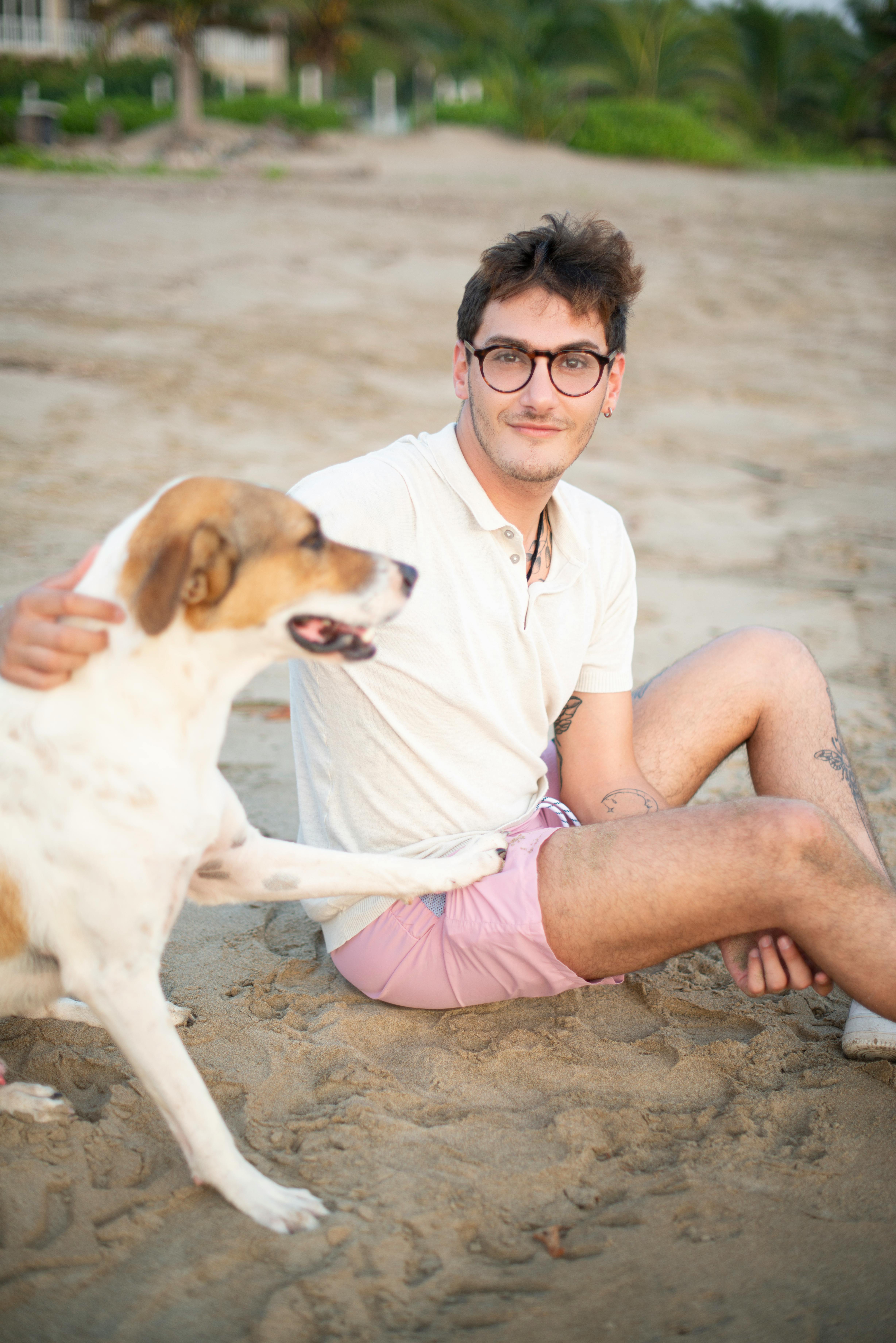 Casual moment of a man with dog at Playa Blanca, capturing summer vibes and companionship.
