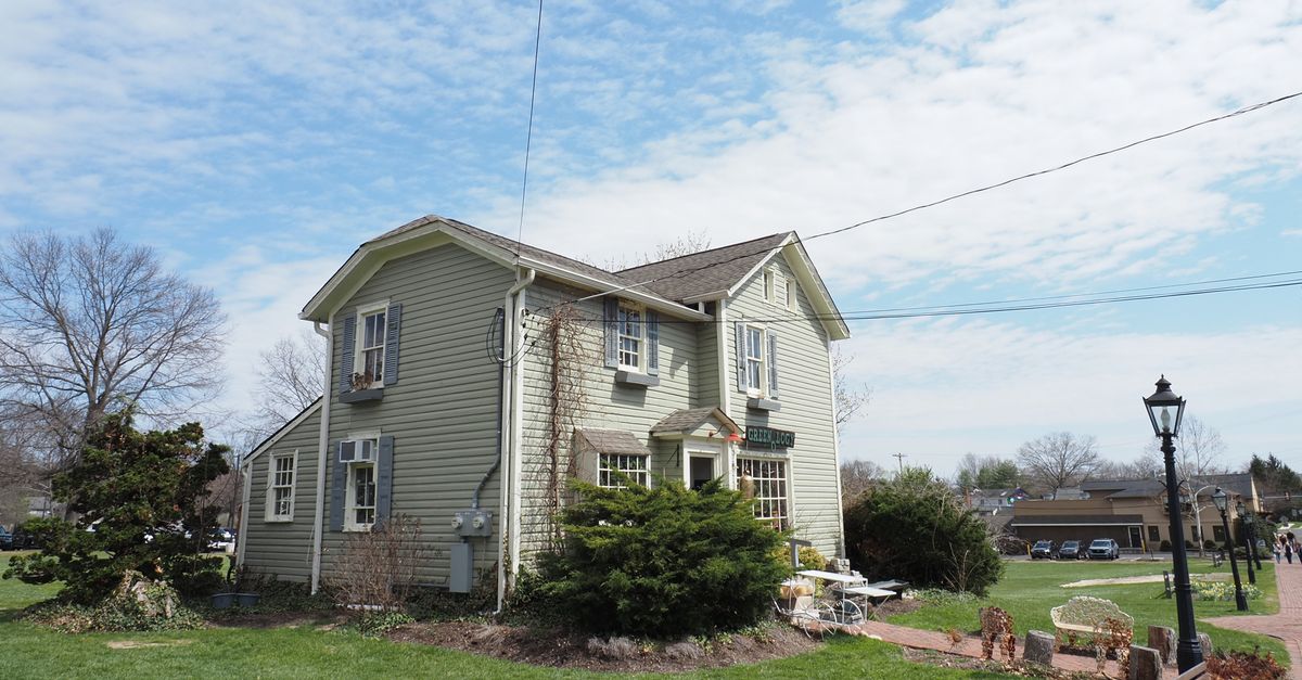 A picturesque historic house in Lahaska, Pennsylvania, USA, set against a clear blue sky.