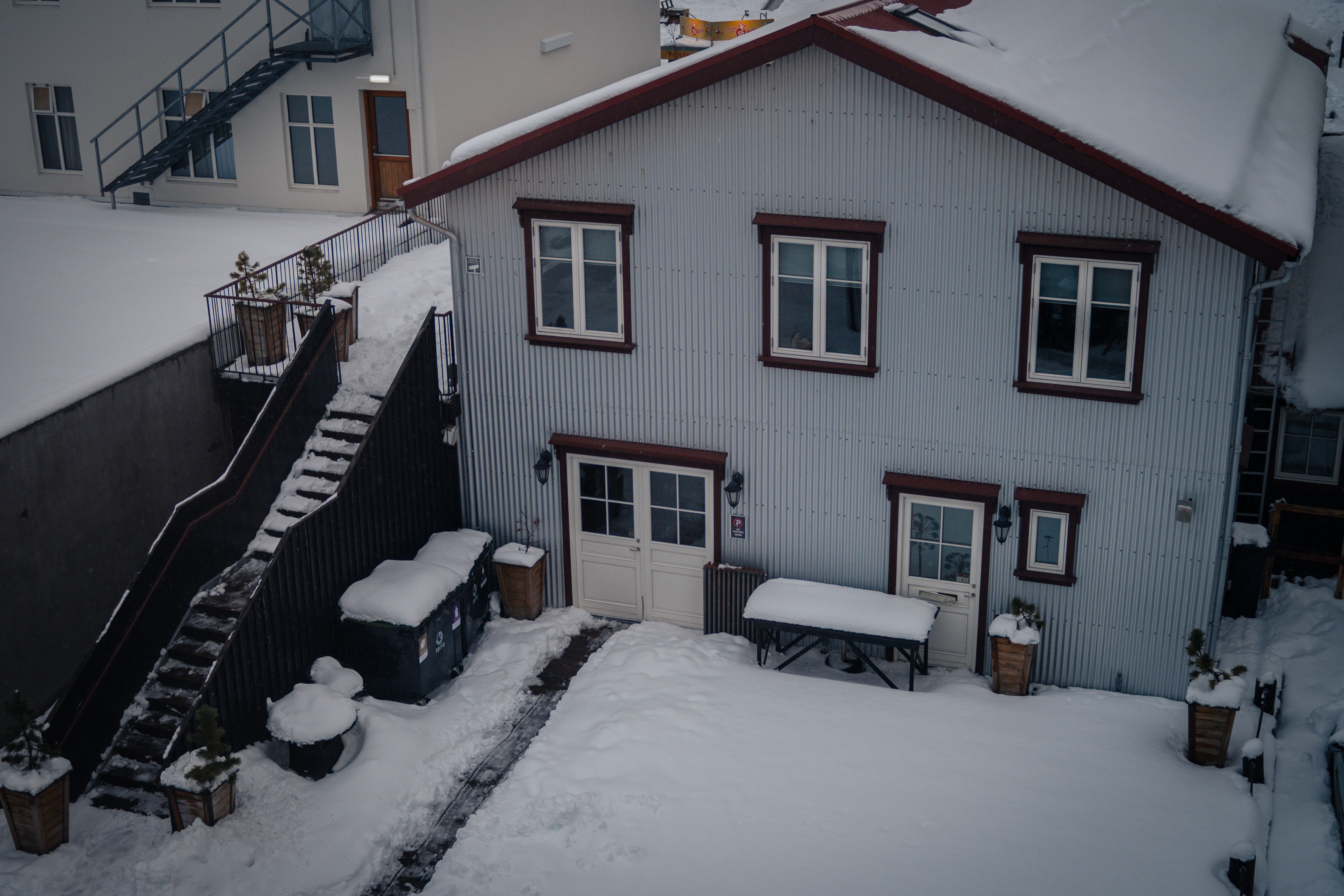 Residential house and exposed exterior areas covered by winter snow