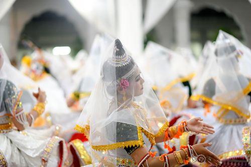 Free Group of women in traditional attire performing a cultural Indian dance indoors. Stock Photo