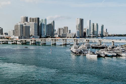 Free A scenic view of Miami skyline and marina, showcasing luxury yachts and modern skyscrapers under a clear blue sky. Stock Photo