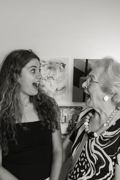 Free A young woman and senior woman share a joyful moment indoors. Stock Photo