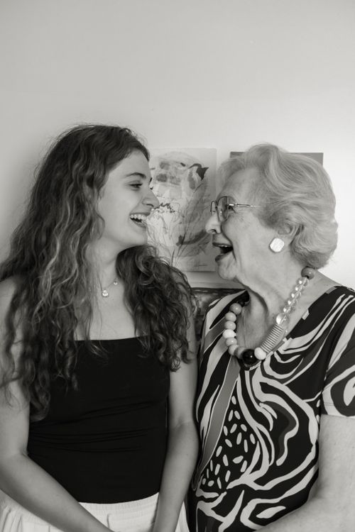 Free Black and white image capturing a joyful moment between a grandmother and granddaughter. Stock Photo