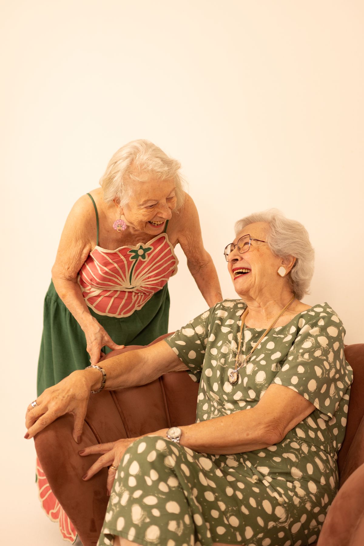 Senior laughing with a companion during a visit