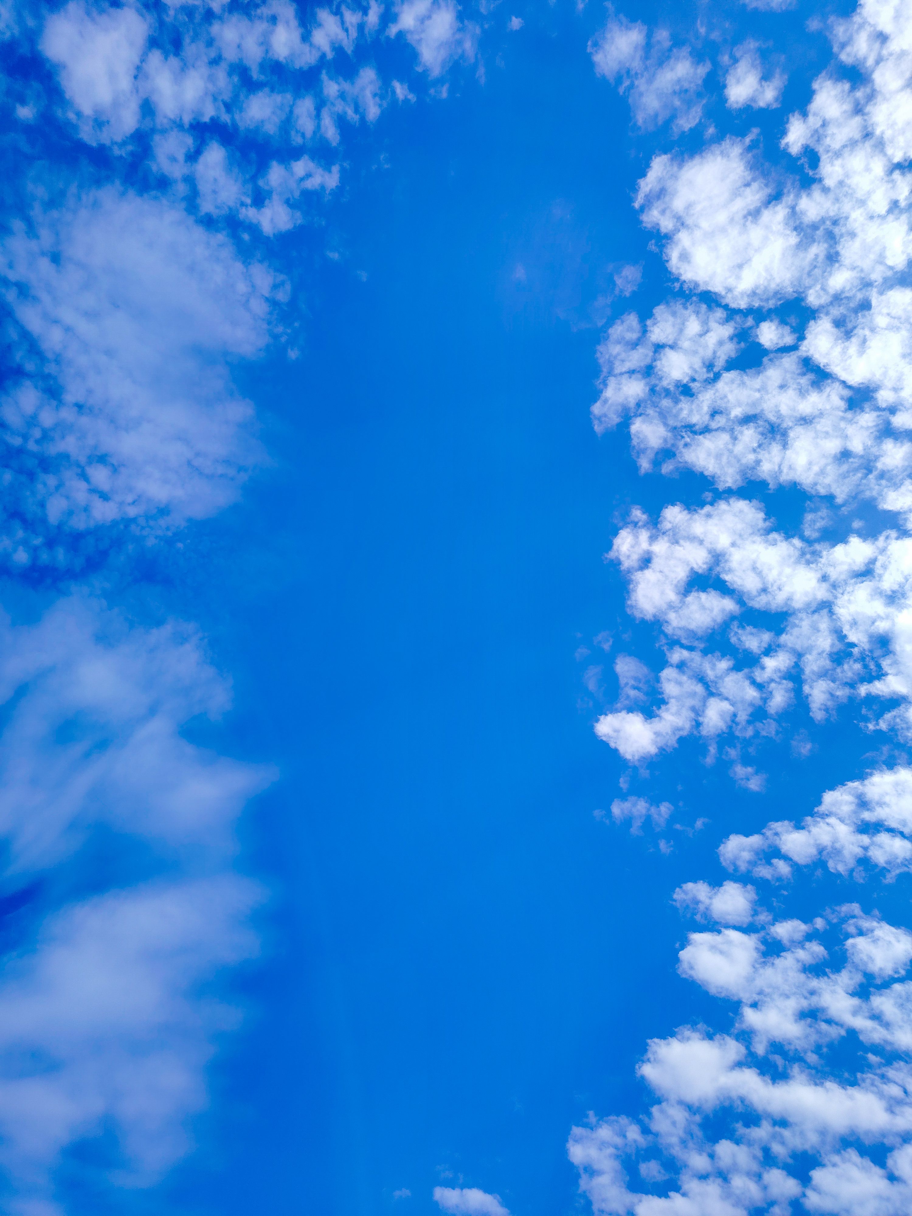 Vivid Blue Sky with Scattered White Clouds · Free Stock Photo
