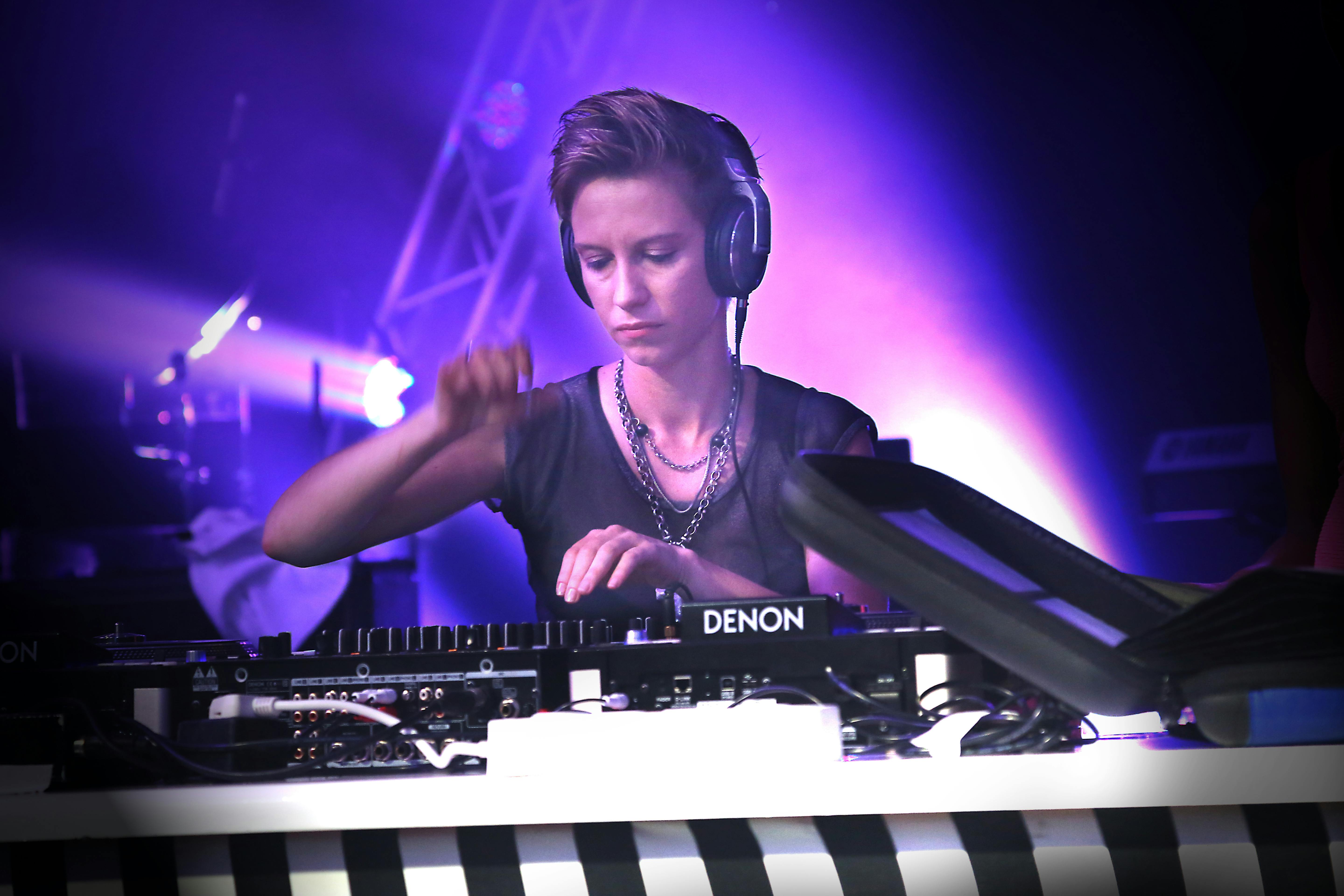 woman playing turntable wearing silver necklace