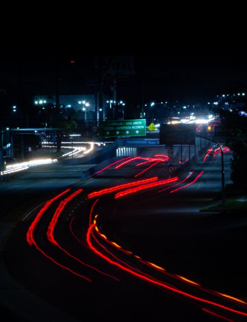 Free Long exposure of light trails on a city highway at night, showcasing dynamic urban life and motion. Stock Photo