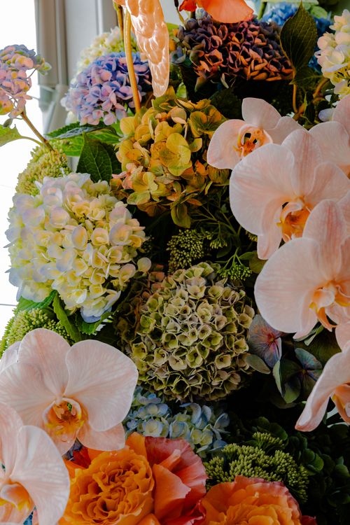 Free Intricate floral arrangement featuring orchids and hydrangeas, showcasing a mix of colors and textures. Stock Photo