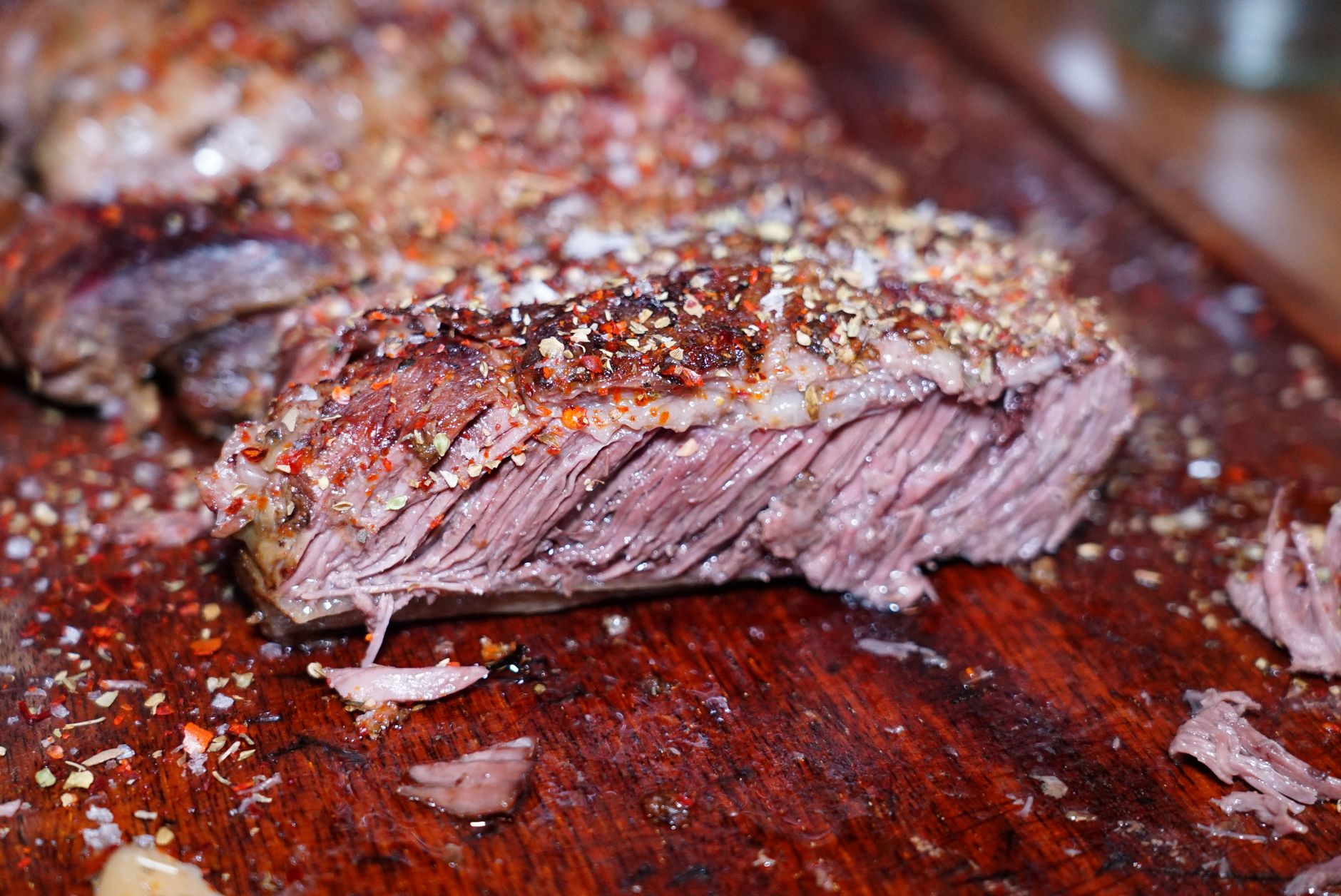 Butcher trimming beef deckle cut with focus on fat layers