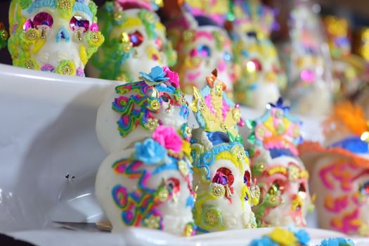 Vibrant sugar skulls decorated for Dia de los Muertos, showcasing Mexican culture.