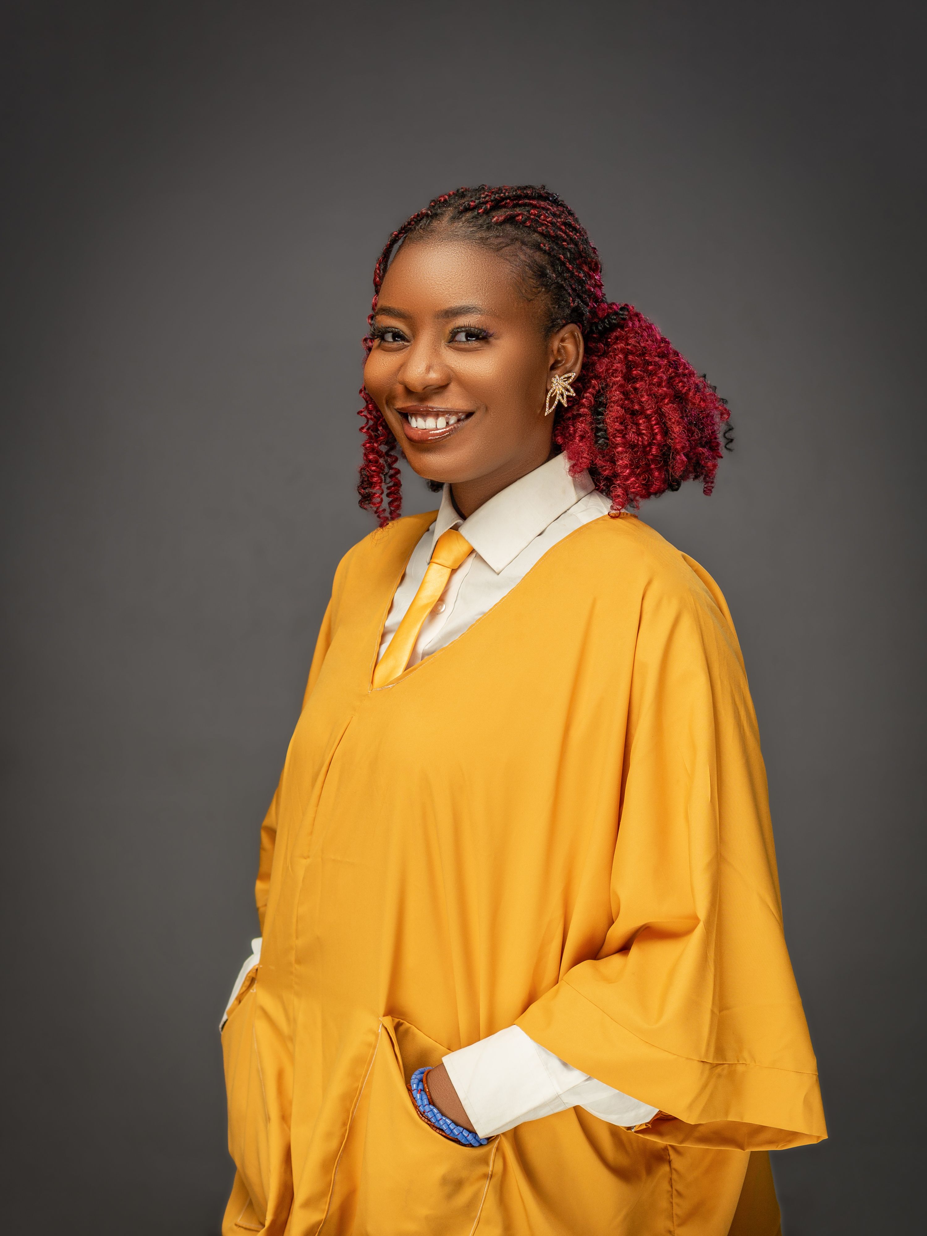 Portrait of Smiling Woman in Yellow Graduation Gown · Free Stock Photo