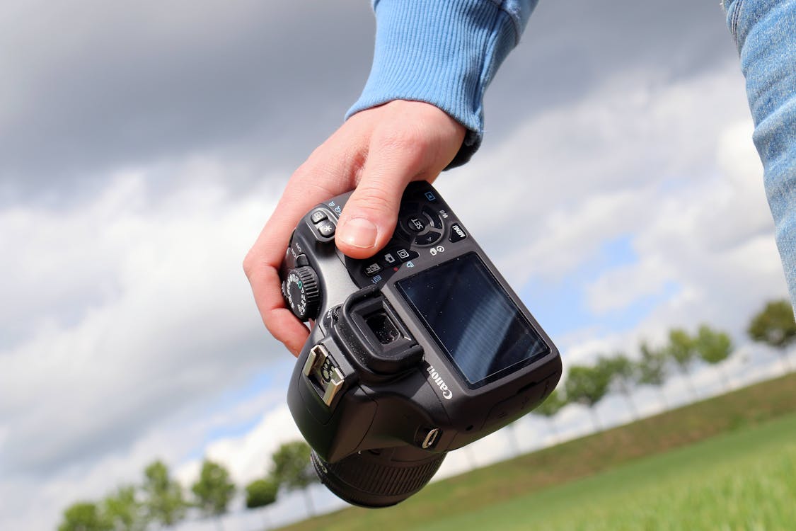 Person Holding Canon Dslr Camera