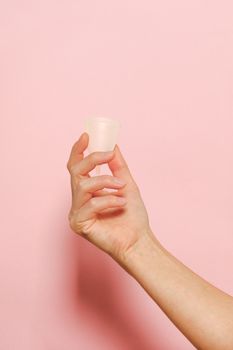 Person Holding White Silicone In Pink Background