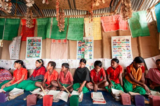 Children studying in a vibrant rural classroom in Bangladesh, highlighting local educational efforts.