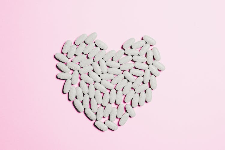 Blue Medicine Pills On Heart Shape 