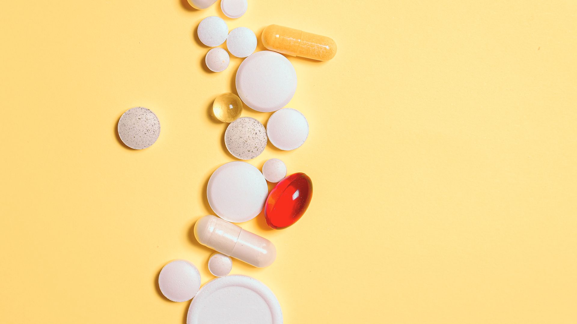 Artvigil 150 Dosage Guide: Unlocking the Right Amount A collection of assorted pills and capsules on a vibrant yellow surface — artvigil 150 dosage guide