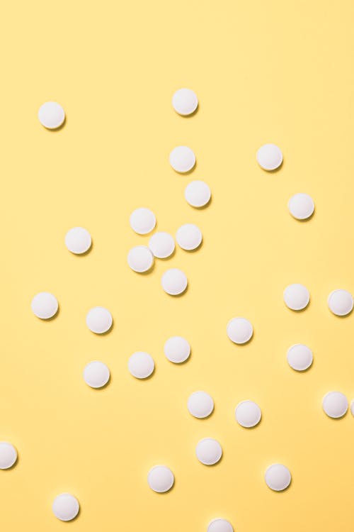 Round Tablets on Yellow Background